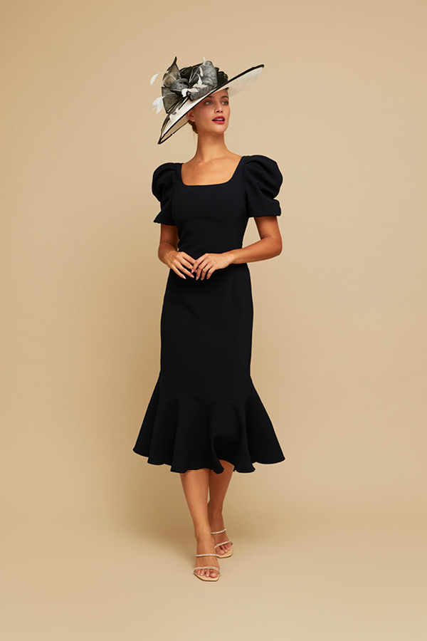 Lady in summer black dress with off sleeves and white hat